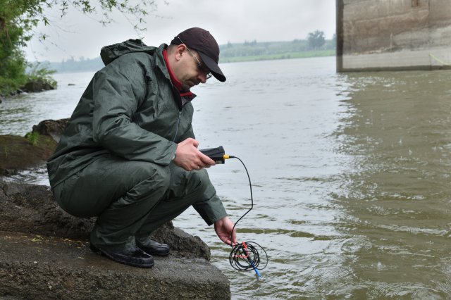 A man sampling in the river