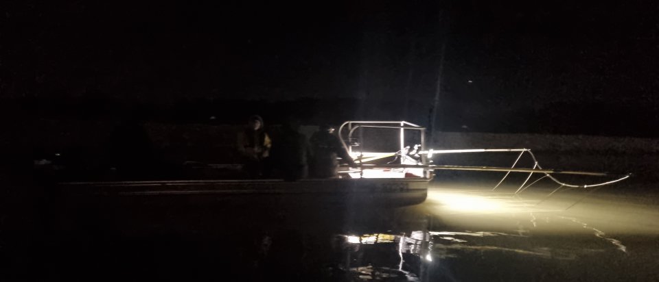Night view of people on a boat on the river 