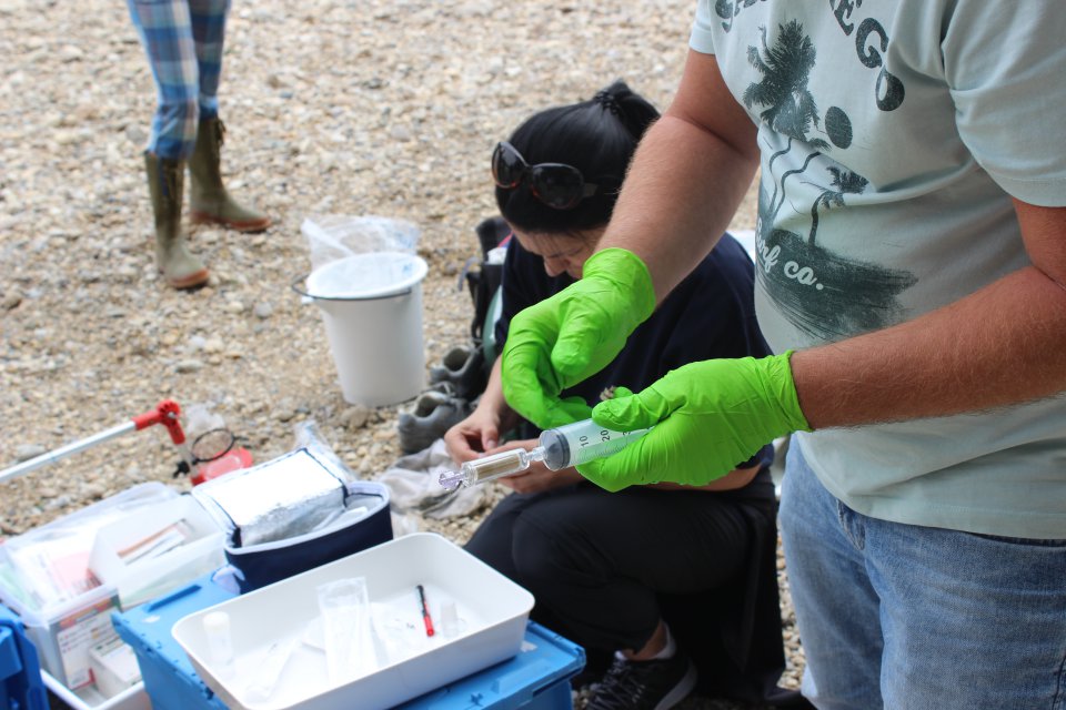 person sampling water 